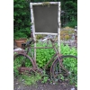This is a photograph of an old bicycle leaning against sign in front of a garden. So pretty for a summertime church bulletin!