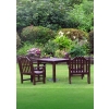 This is a photograph of a wood table and chairs next to a beautiful garden. Great for church bulletin in summer!